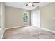 Bright bedroom with neutral walls, ceiling fan, and plush carpeting at 10 Locust Run Crse, Ocala, FL 34472