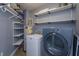 Convenient laundry room with washer, dryer, and storage shelves at 100 S Eola Dr # 609, Orlando, FL 32801