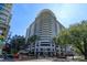 Modern high rise building with upscale storefronts and palm trees at 100 S Eola Dr # 609, Orlando, FL 32801