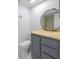 Updated bathroom with gray vanity, a large mirror, and a beige countertop at 4548 Summergrove Ave, Orlando, FL 32812