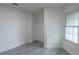 Bright bedroom with gray flooring, a large window, and a spacious closet at 4548 Summergrove Ave, Orlando, FL 32812