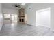 Spacious living room with stone fireplace and gray vinyl flooring at 4548 Summergrove Ave, Orlando, FL 32812