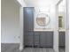 Updated bathroom with gray vanity, a large mirror, and a beige countertop at 4548 Summergrove Ave, Orlando, FL 32812
