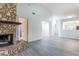 Open concept living area with stone fireplace and wood-look floors at 4548 Summergrove Ave, Orlando, FL 32812