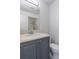 Clean bathroom with gray vanity, a large mirror and a beige countertop at 4548 Summergrove Ave, Orlando, FL 32812