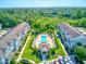 Complex of townhouses with a central pool and lush green space at 590 Piazza Pt, Oviedo, FL 32765