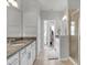 Elegant bathroom with double vanity, granite countertop and shower at 590 Piazza Pt, Oviedo, FL 32765