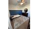 Bright bedroom featuring a full-size bed, stylish dresser, and accent wall at 590 Piazza Pt, Oviedo, FL 32765
