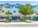 Townhome community with two-story buildings, attached garages, and landscaping at 590 Piazza Pt, Oviedo, FL 32765