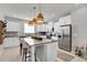 Modern kitchen with granite countertops, stainless steel appliances, and an island at 590 Piazza Pt, Oviedo, FL 32765