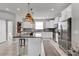Modern kitchen with granite countertops, stainless steel appliances, and an island at 590 Piazza Pt, Oviedo, FL 32765