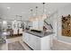 Modern kitchen with granite countertops, island, and open concept view to dining area at 590 Piazza Pt, Oviedo, FL 32765