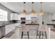 Modern kitchen with granite countertops, stainless steel appliances, and an island at 590 Piazza Pt, Oviedo, FL 32765