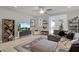 Relaxing living room with sectional sofa, large TV, and built-in shelving at 590 Piazza Pt, Oviedo, FL 32765