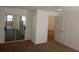 Large bedroom with carpet, mirrored closet doors, and access to another room at 32525 Oak Park Dr, Leesburg, FL 34748