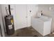 Interior laundry room with washer, dryer, and water heater at 32525 Oak Park Dr, Leesburg, FL 34748