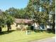 House exterior with two car garage and landscaping at 32525 Oak Park Dr, Leesburg, FL 34748