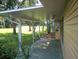 Covered patio with paver stones and backyard view at 32525 Oak Park Dr, Leesburg, FL 34748