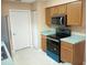 Kitchen with wood cabinets, teal countertops, and stainless steel appliances at 32525 Oak Park Dr, Leesburg, FL 34748