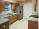 Kitchen with wood cabinets, teal countertops, and stainless steel appliances at 32525 Oak Park Dr, Leesburg, FL 34748