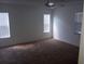 Bright bedroom with carpet, ceiling fan and window blinds at 32525 Oak Park Dr, Leesburg, FL 34748