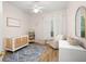 Charming Bedroom with crib, armchair, and ample storage at 858 Creston Dr, Maitland, FL 32751