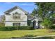 Two-story house with gray siding, landscaping, and a spacious lawn at 858 Creston Dr, Maitland, FL 32751