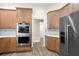 Modern kitchen, stainless steel appliances, light wood cabinets, and marble countertops at 858 Creston Dr, Maitland, FL 32751