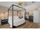Bright main bedroom, king-size bed, and en-suite bathroom access at 858 Creston Dr, Maitland, FL 32751