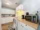 White kitchen with granite countertops and appliances at 544 S Cottage Hill Rd, Orlando, FL 32805