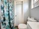 Bathroom with shower, toilet and floral shower curtain at 544 S Cottage Hill Rd, Orlando, FL 32805
