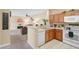 Fully equipped kitchen with ample cabinetry and white appliances at 3174 Feltrim Pl # 201, Kissimmee, FL 34747
