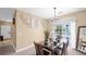 Bright dining room with table set for four and access to balcony at 3174 Feltrim Pl # 201, Kissimmee, FL 34747