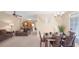 Open concept dining room with seating for six adjacent to a kitchen and living room at 3174 Feltrim Pl # 201, Kissimmee, FL 34747