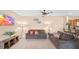 Living room with two sofas, a TV, and a view of the kitchen at 3174 Feltrim Pl # 201, Kissimmee, FL 34747