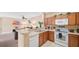 Modern kitchen with breakfast bar and view of living room at 3174 Feltrim Pl # 201, Kissimmee, FL 34747