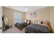Two twin beds in a bright bedroom with a large window and ceiling fan at 3174 Feltrim Pl # 201, Kissimmee, FL 34747