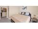 King-size bed in a spacious bedroom with a view of the kitchen at 3174 Feltrim Pl # 201, Kissimmee, FL 34747