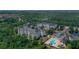 Aerial view of apartment buildings, pool, and surrounding landscape at 3174 Feltrim Pl # 201, Kissimmee, FL 34747