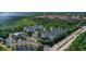 Aerial view of apartment buildings, landscaping, and a pond at 3174 Feltrim Pl # 201, Kissimmee, FL 34747