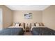 Bedroom featuring two twin beds, ceiling fan and artwork at 3174 Feltrim Pl # 201, Kissimmee, FL 34747