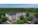 Apartment building with parking lot and surrounding landscape at 3174 Feltrim Pl # 201, Kissimmee, FL 34747