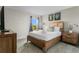 Bedroom with wood bed frame, window, and nightstand at 2874 Stanza Ct, Kissimmee, FL 34746