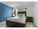 Bedroom with dark wood bed frame and blue accent wall at 2874 Stanza Ct, Kissimmee, FL 34746