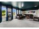 Spacious game room with leather sectional sofa, popcorn machine, and a dark blue ceiling at 2874 Stanza Ct, Kissimmee, FL 34746