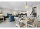 Dining area with white farmhouse table and view into the living room and kitchen at 2874 Stanza Ct, Kissimmee, FL 34746