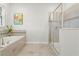 Bathroom with soaking tub, walk-in shower, and tile floors at 2874 Stanza Ct, Kissimmee, FL 34746