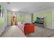Relaxing game room with coral sofa, large TV, and light green walls at 2874 Stanza Ct, Kissimmee, FL 34746