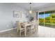 Bright dining room with white table and chairs, overlooking the pool at 2874 Stanza Ct, Kissimmee, FL 34746