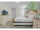 Main bedroom with large bed, dresser, and TV at 2874 Stanza Ct, Kissimmee, FL 34746